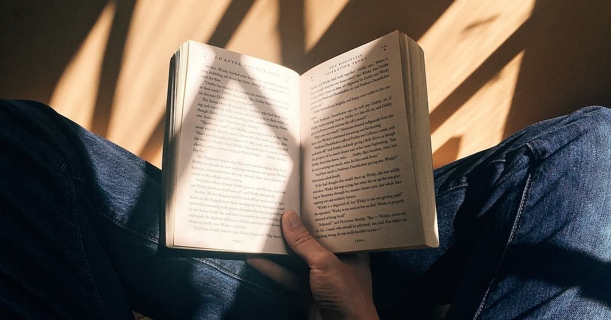 Reading a book (Image via Getty Images)